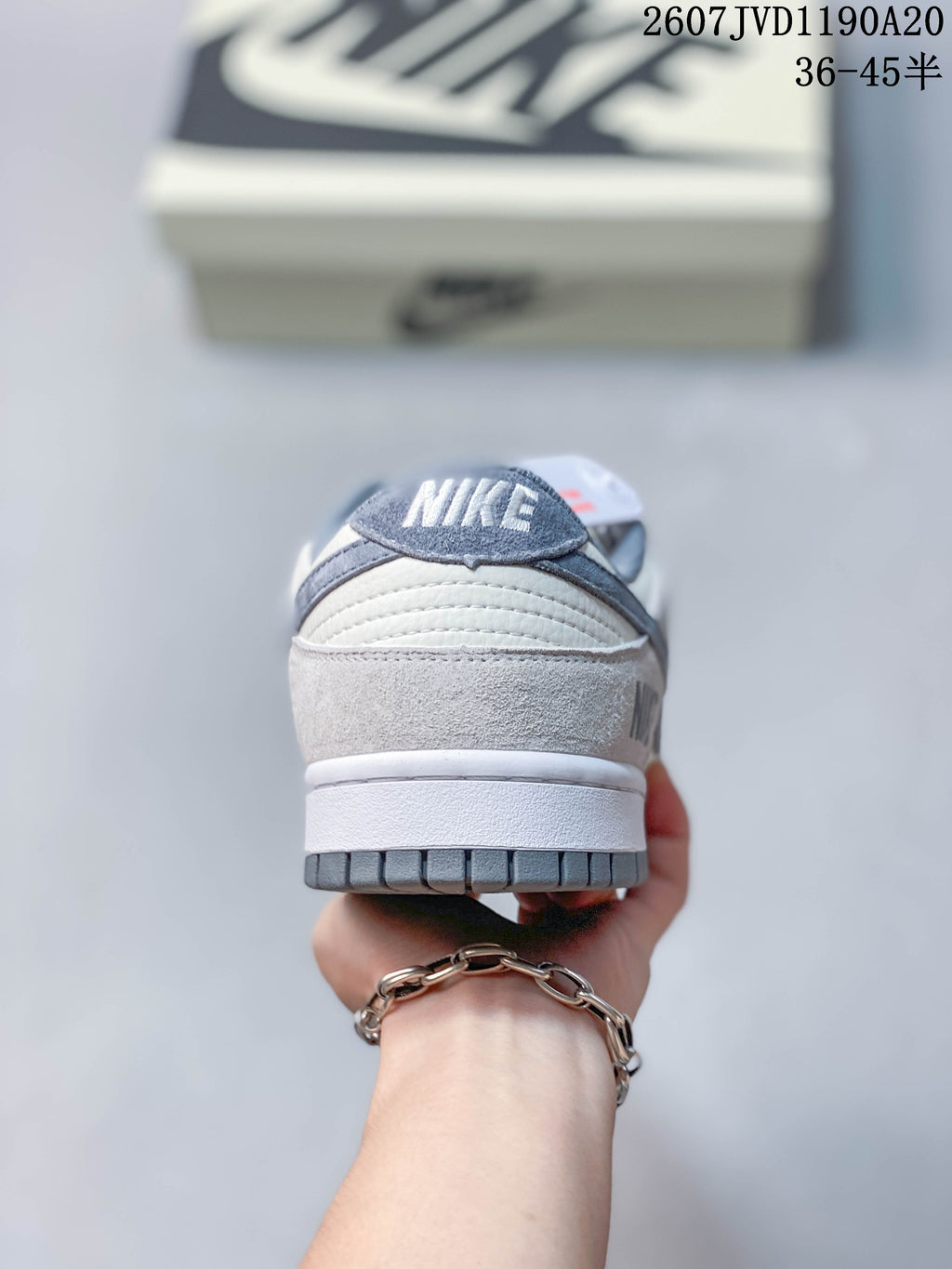 Rear view showing the padded heel, layered panels, and grey outsole of the sneaker.