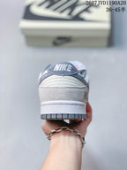 Rear view showing the padded heel, layered panels, and grey outsole of the sneaker.