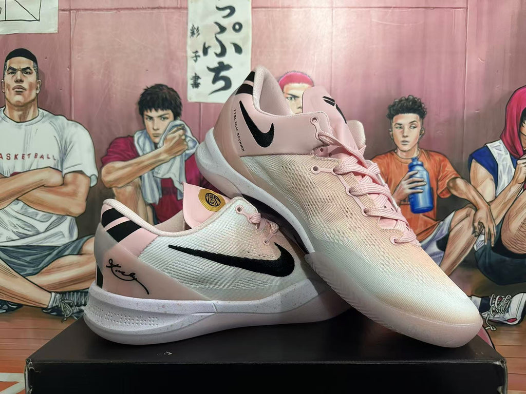 Angled view of two pink Nike sneakers displaying the black Swoosh, laces and textured white soles.