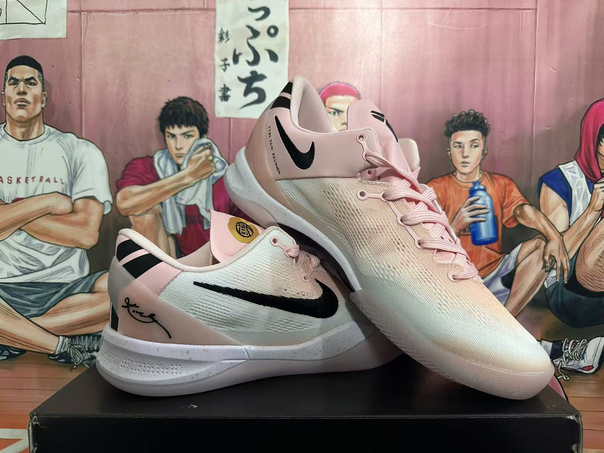 Angled view of two pink Nike sneakers displaying the black Swoosh, laces and textured white soles.