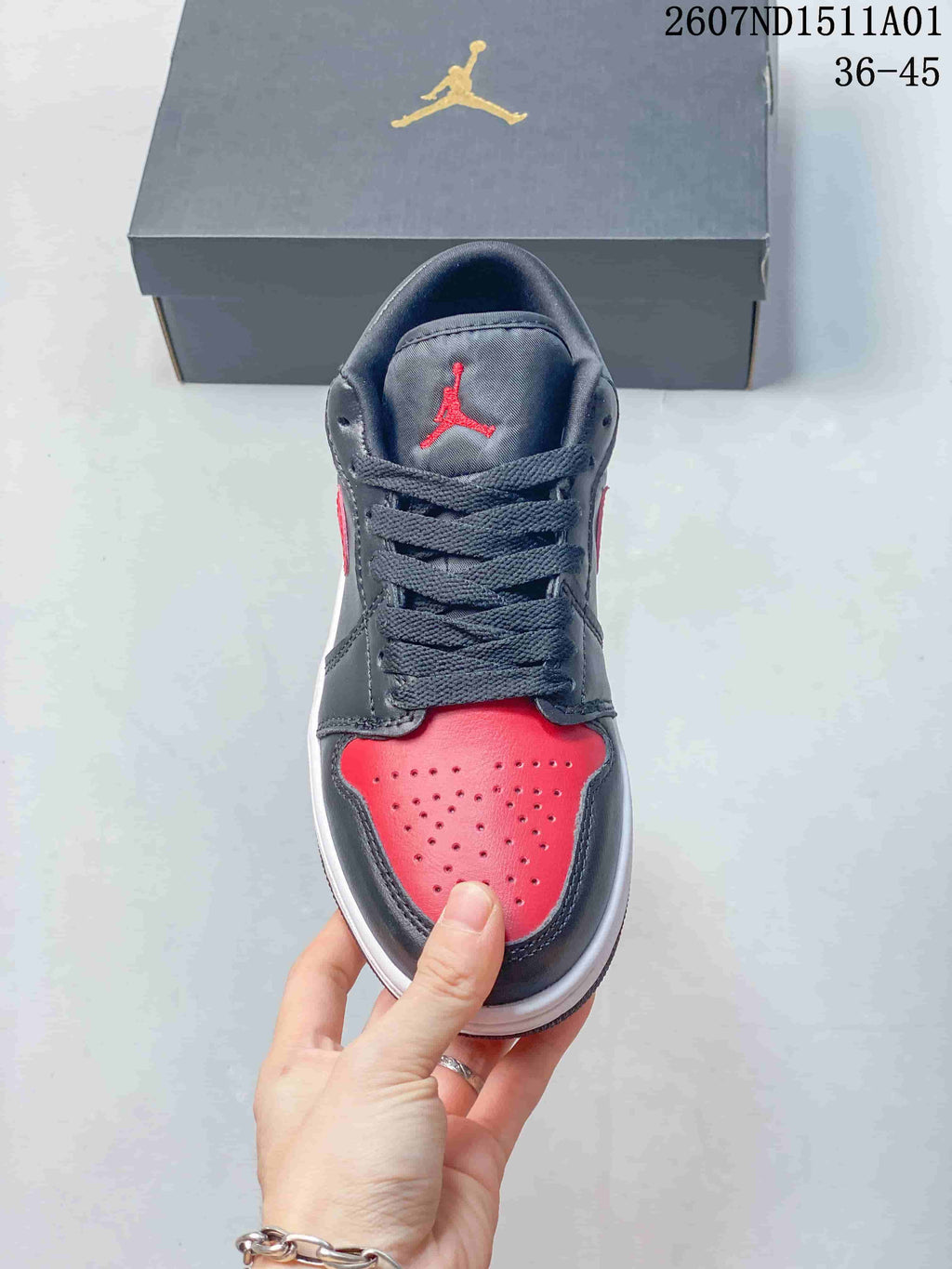 Top view of a black and red Jordan sneaker showing the perforated toe and laces