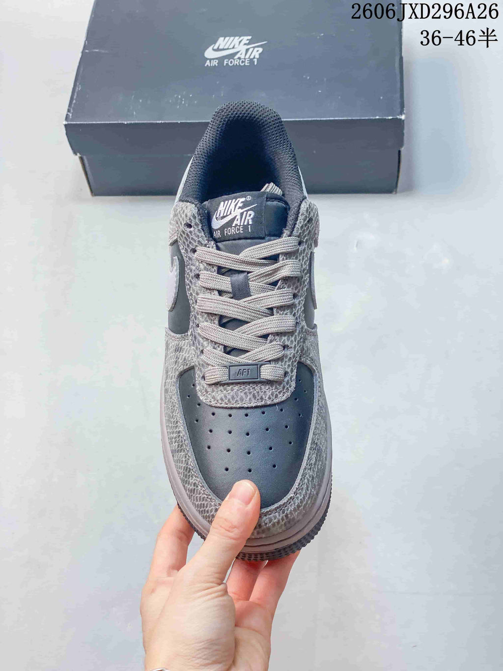 Front view showing the perforated toe box, tonal laces, tongue label, and patterned upper.