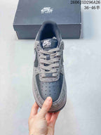 Front view showing the perforated toe box, tonal laces, tongue label, and patterned upper.