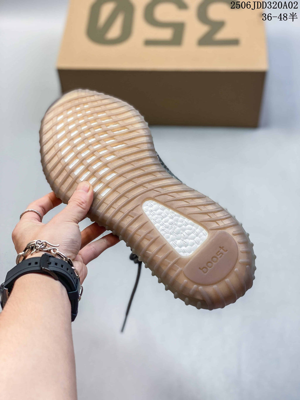 Close-up of the translucent ribbed outsole and white midsole section of the gray sneaker.