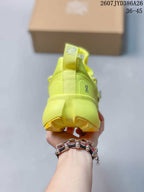 Rear view of the neon yellow sneaker showing the heel pull tab, On branding, and sculpted heel structure.