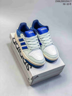 Pair of white and royal blue adidas Entrap sneakers displayed on an adidas shoebox; image text shows 2506JDD320A17 and a 36–45 half-size range.