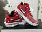 Pair of red basketball shoes displayed together, showing the Swoosh graphics, patterned panels, and maple leaf heel detail.