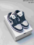 Black and white low-top Jordan sneakers with reflective studded detailing shown on a Jordan shoebox; style code and size range text are visible above.