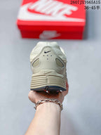 Rear view showing the padded heel collar, heel overlays, and layered outsole design.