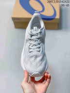Top view of the light white and gray ASICS running shoe showing the lace-up construction and ventilated-looking forefoot panel.