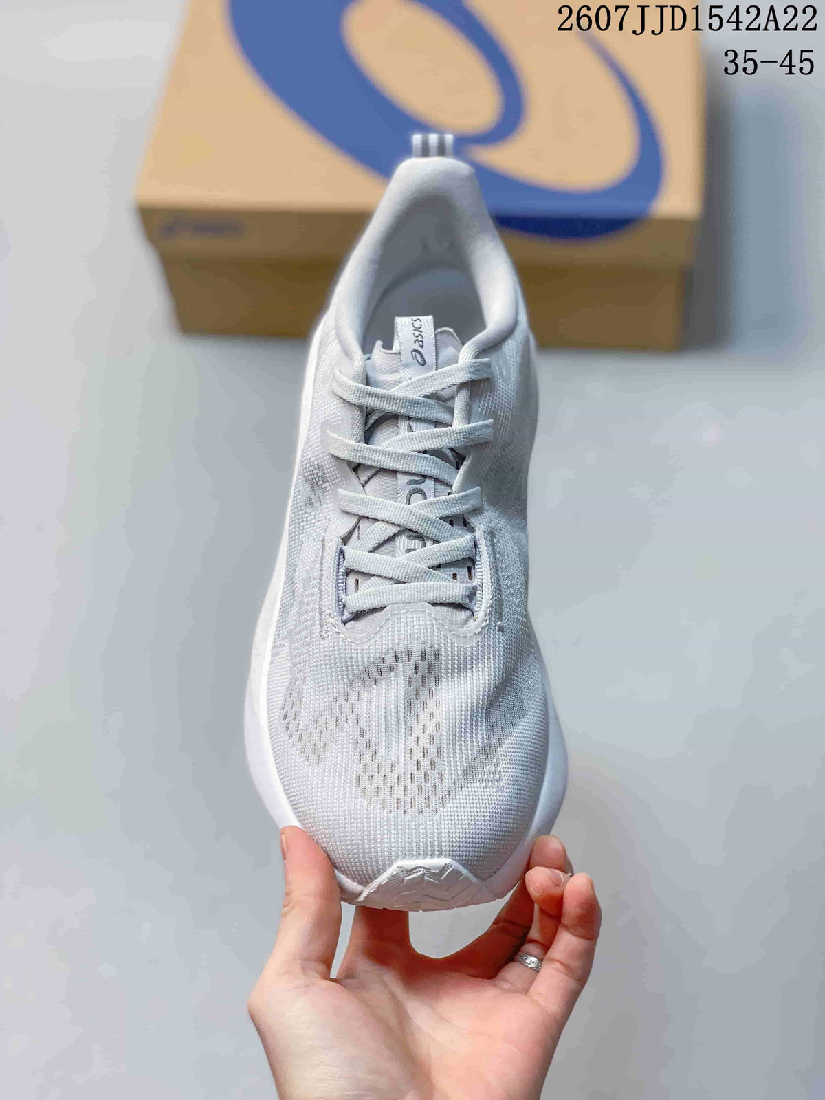 Top view of the light white and gray ASICS running shoe showing the lace-up construction and ventilated-looking forefoot panel.