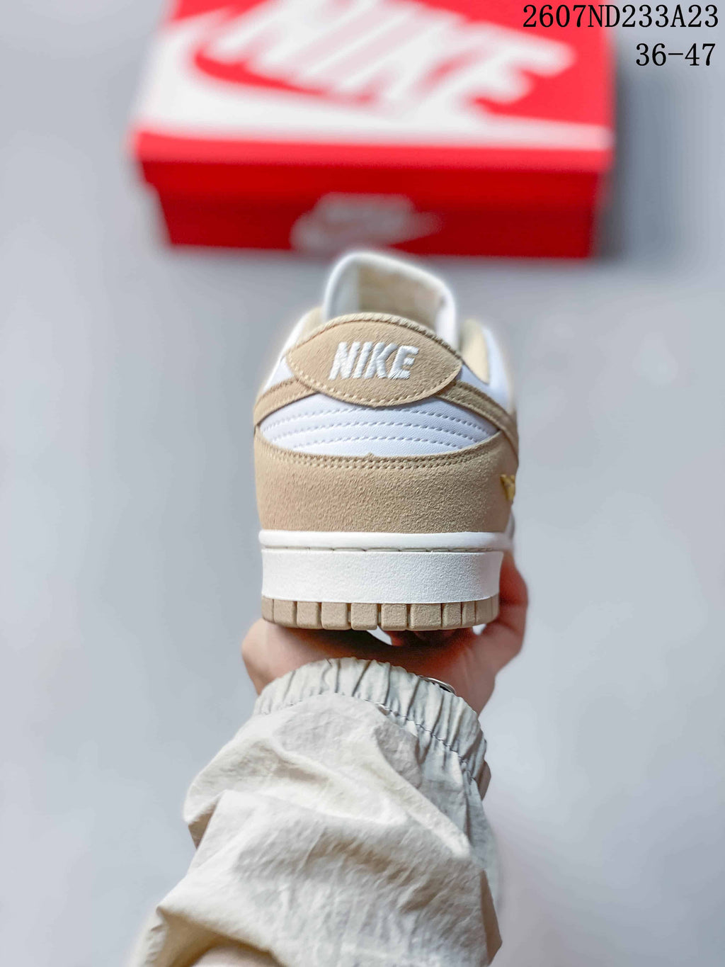 Rear view showing the beige heel panel, white midsole, and padded collar.