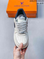 Front view showing the perforated toe, patterned laces, and dark padded collar