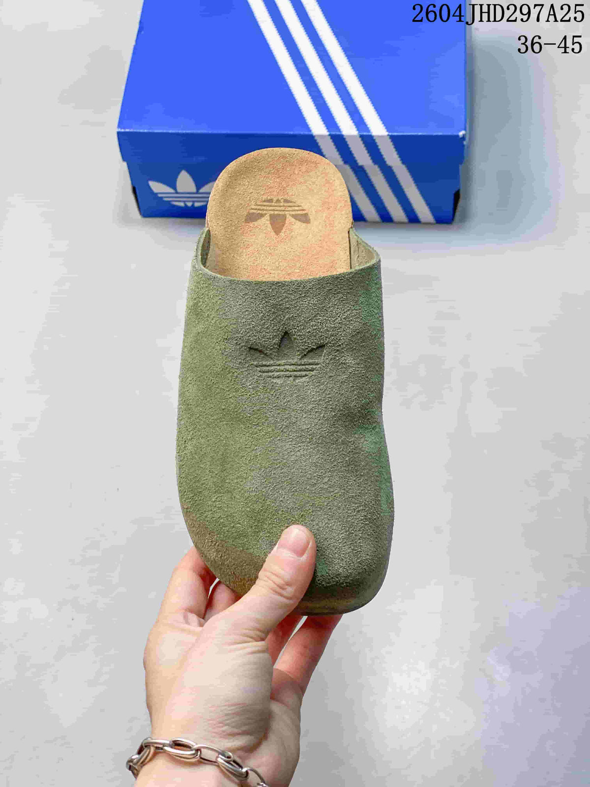 Top view of a green mule showing its closed toe and branded footbed