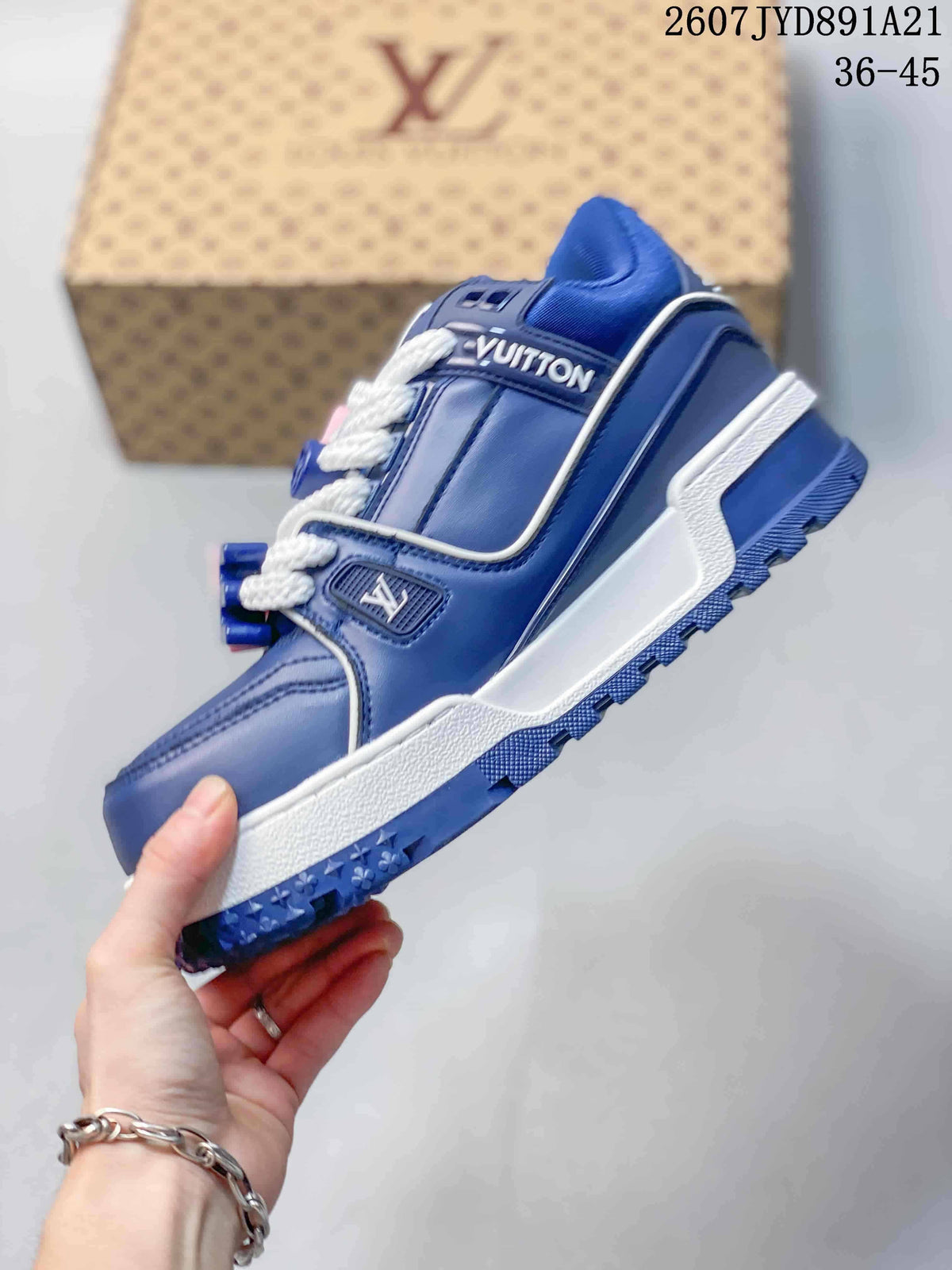 Side view of a blue low-top sneaker showing white piping, white layered midsole, blue tread, and lace detailing.