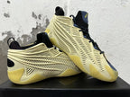 Pair of cream, black, navy and yellow sneakers shown from the side