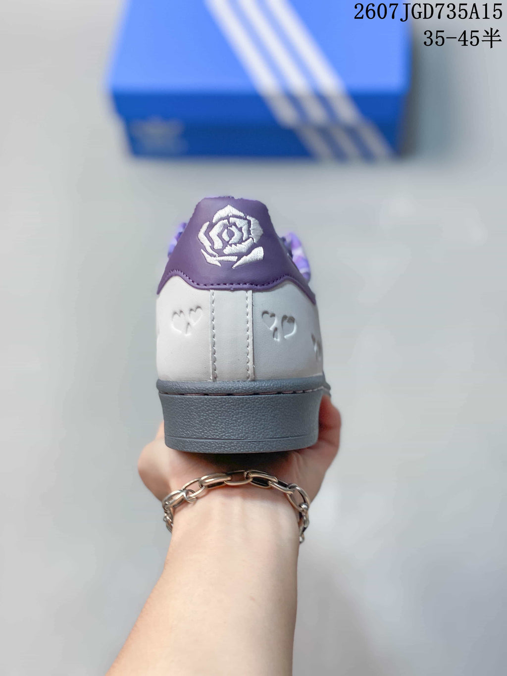 Rear view of the sneaker showing the purple heel tab, patterned collar lining and gray heel outsole.