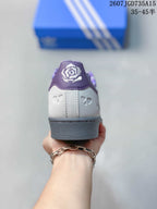 Rear view of the sneaker showing the purple heel tab, patterned collar lining and gray heel outsole.