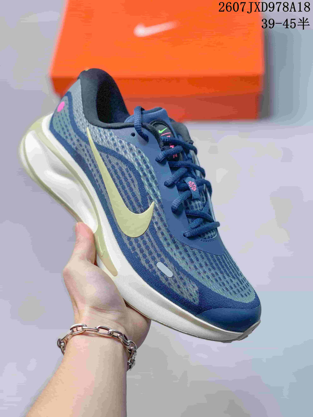 Blue and pale yellow Nike Journey Run sneaker with a patterned textile-style upper and sculpted cushioned sole.