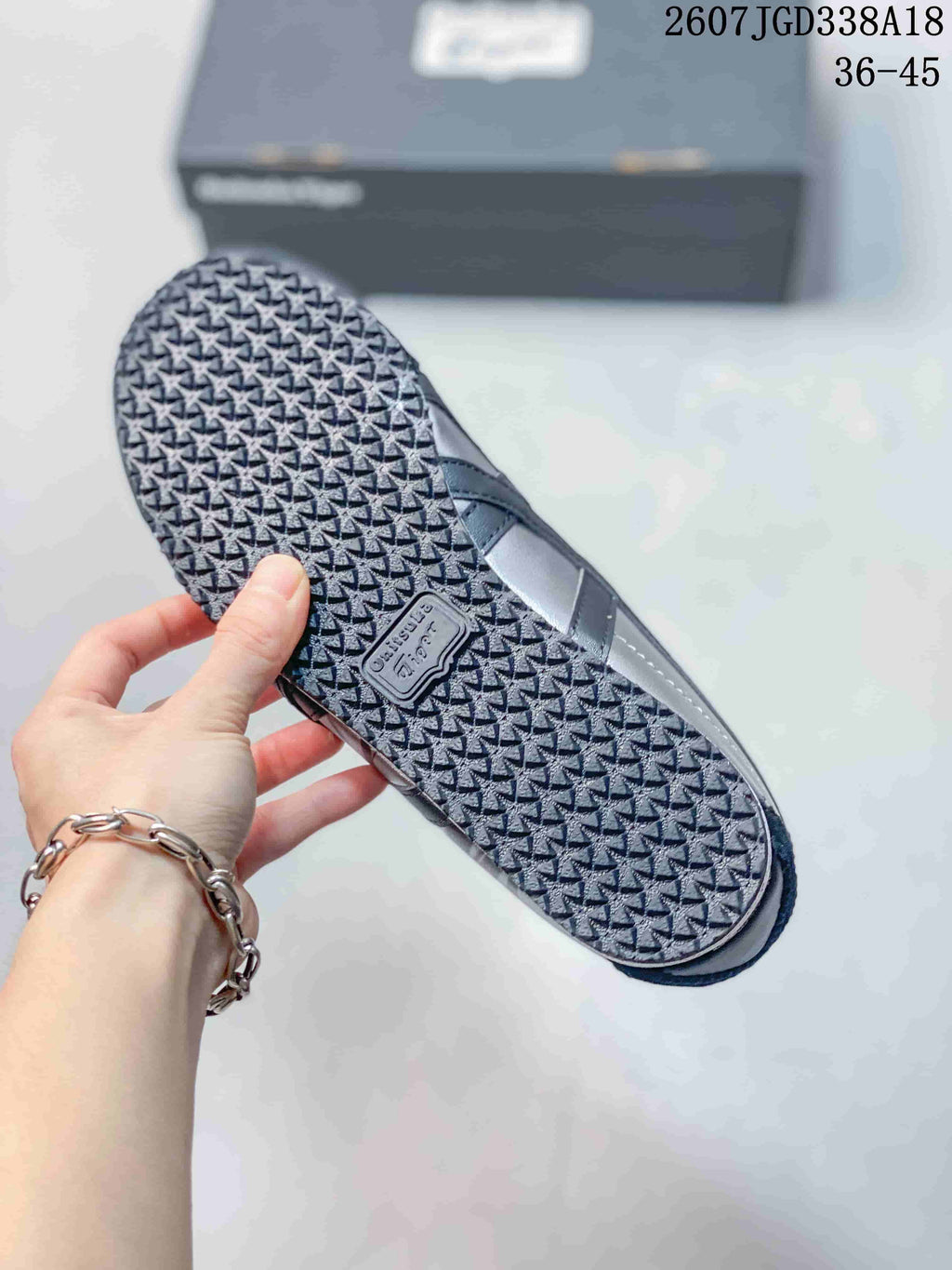 Outsole view showing the textured rubber tread and molded branding detail.