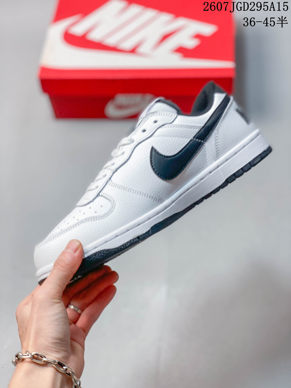Side profile of the white low-top sneaker showing the black Swoosh, white midsole, and black outsole.