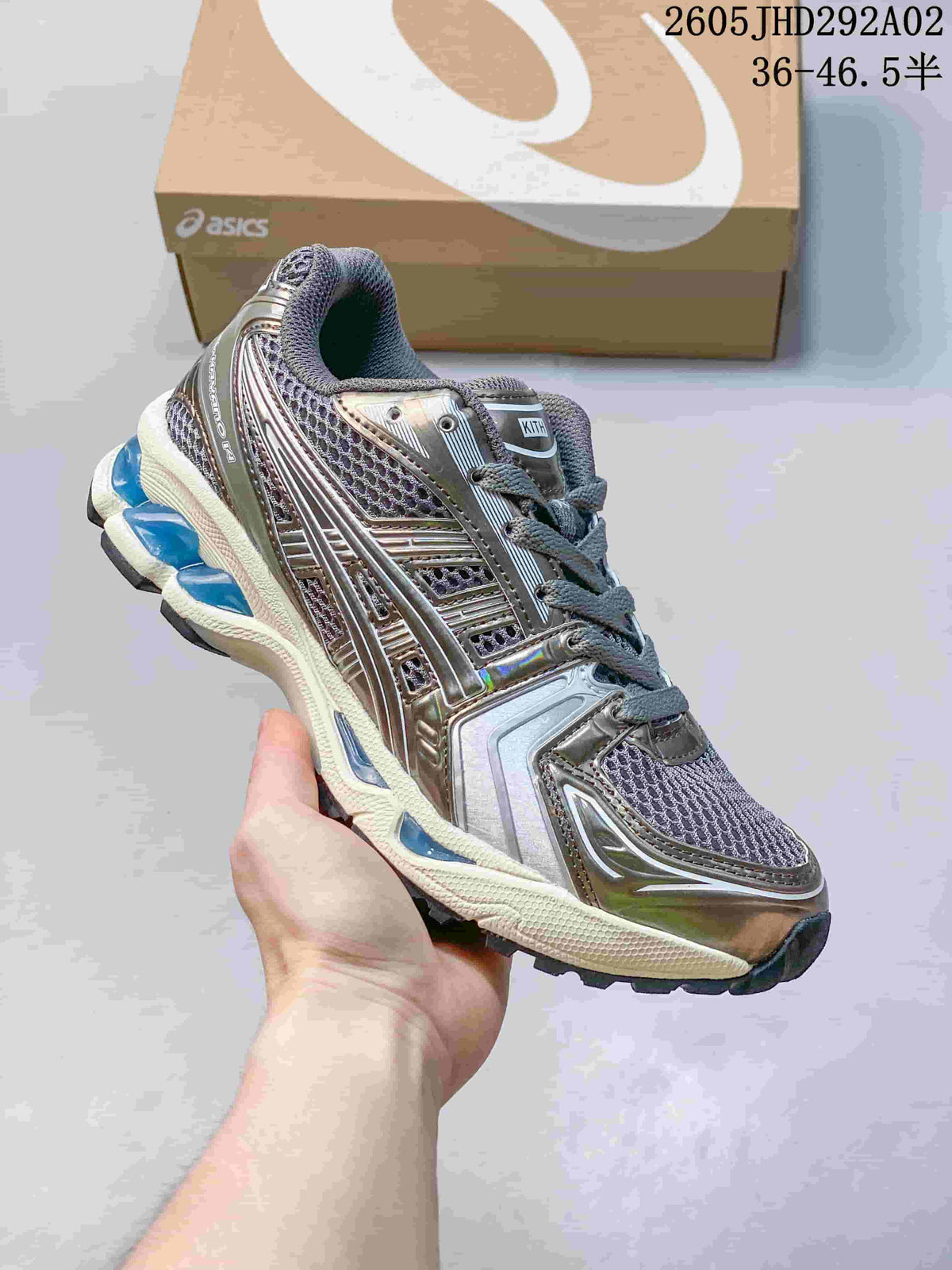 ASICS GEL-KAYANO 14 sneaker in metallic silver and dark gray with blue accents.