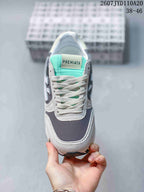 Front view of a Premiata sneaker with grey overlays, a navy textile toe area, white laces and a mint-green tongue; image text shows 2607 TYD110A20 and 38–46.