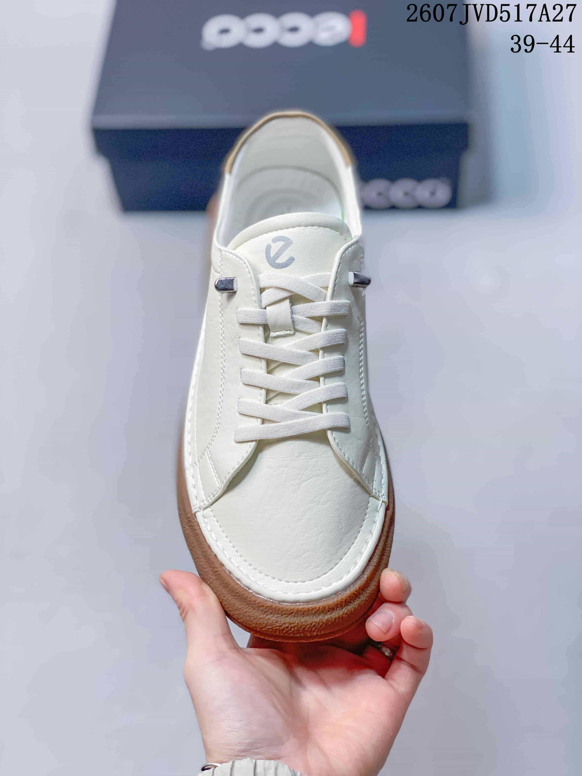 Top view of the white lace-up sneaker showing the rounded toe and branded tongue.