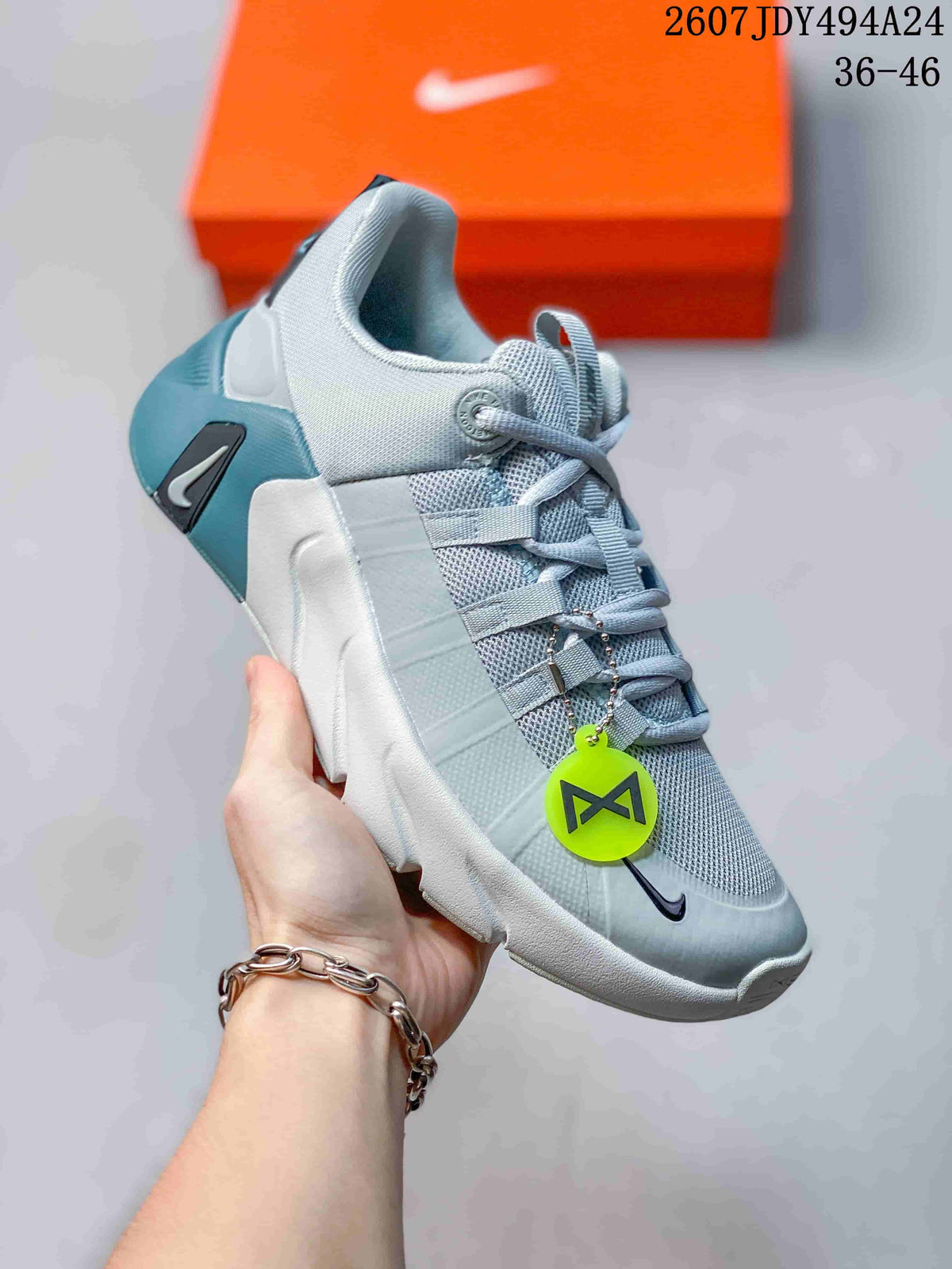 Angled side view showing the light gray upper, blue heel detail, and black Nike branding.