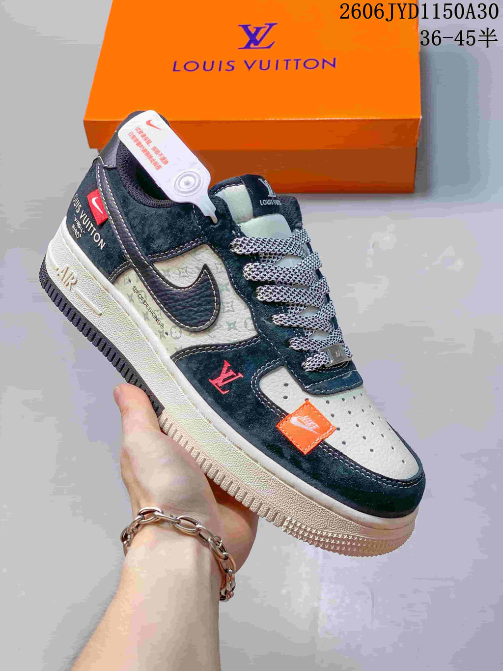 Close view of a black and gray low-top sneaker with patterned laces and contrasting orange details