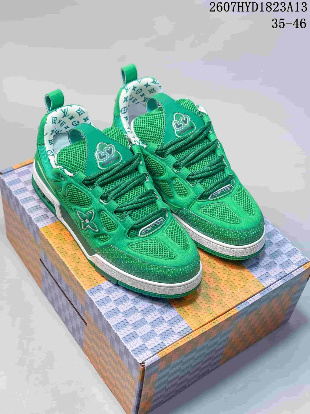 Pair of green Louis Vuitton Trainer sneakers displayed on a patterned box, with style code 2607HYD1823A13 and size range 35–46 visible at the top.