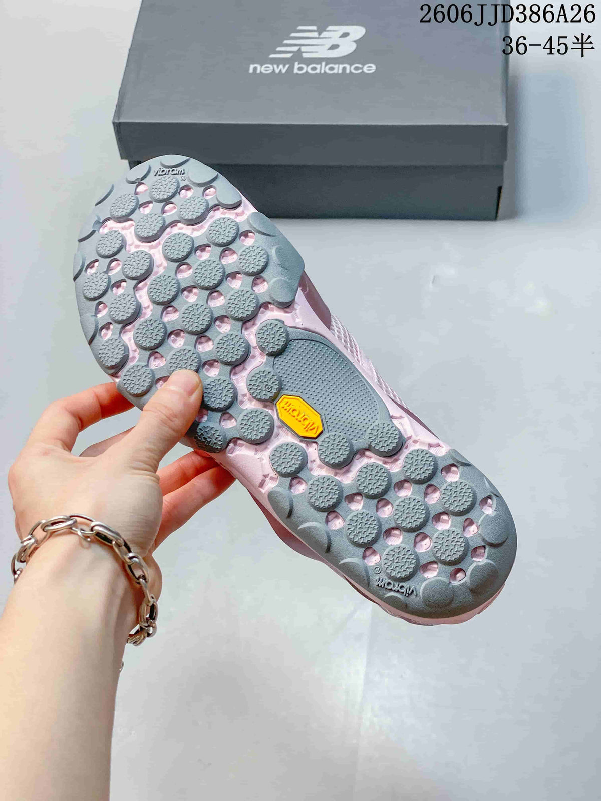 Close-up of the gray lugged outsole with visible Vibram branding on a pink sneaker.