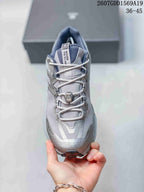 Front view of the shoe showing the mesh-style tongue, crisscross laces, lace guides, and reinforced toe area.