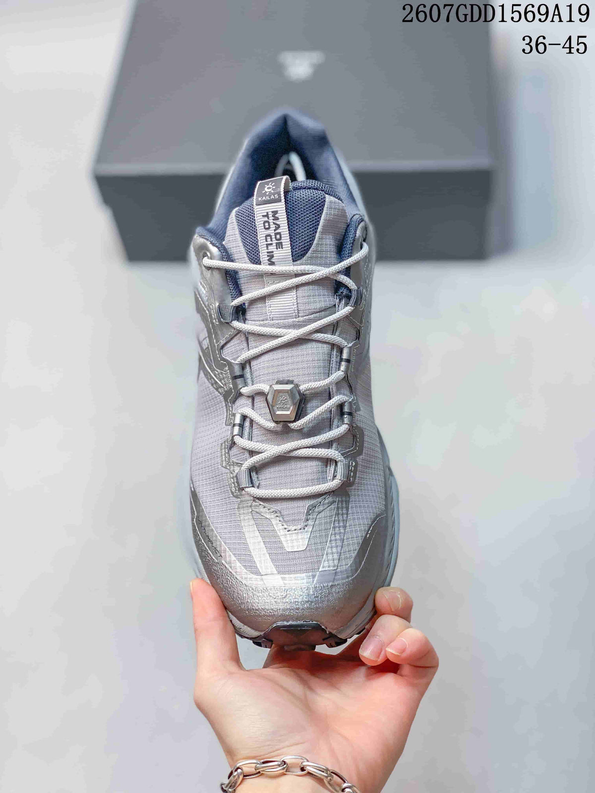 Front view of the shoe showing the mesh-style tongue, crisscross laces, lace guides, and reinforced toe area.