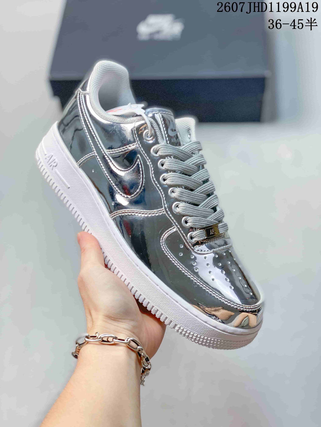 Angled side view of the metallic silver sneaker showing the reflective upper, side swoosh detail, white midsole and textured outsole; overlay text shows size range 36–45.