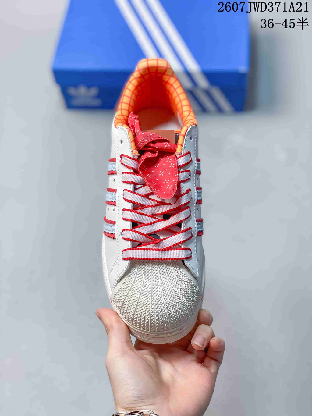 Front view showing the textured shell toe, red laces, and patterned tongue detail.