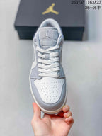 Top view showing white laces, a light grey tongue, and perforations across the white toe box.