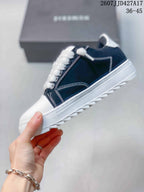 Side view of a navy and white Numeris sneaker showing contrast stitching, layered white sole, and tread edge.