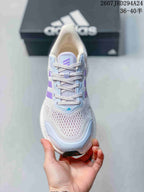 Top view showing the mesh toe box, light blue overlays, lilac tongue detail, and laces.