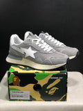 Pair of grey BAPE ROAD STA EXPRESS sneakers displayed on a camouflage BAPE shoebox; the box label shows EU 42 and Grey.