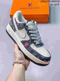 Cream and dark monogram-print low-top sneaker with a contrast swoosh, held in front of an orange box.