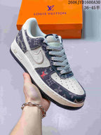Cream and dark monogram-print low-top sneaker with a contrast swoosh, held in front of an orange box.