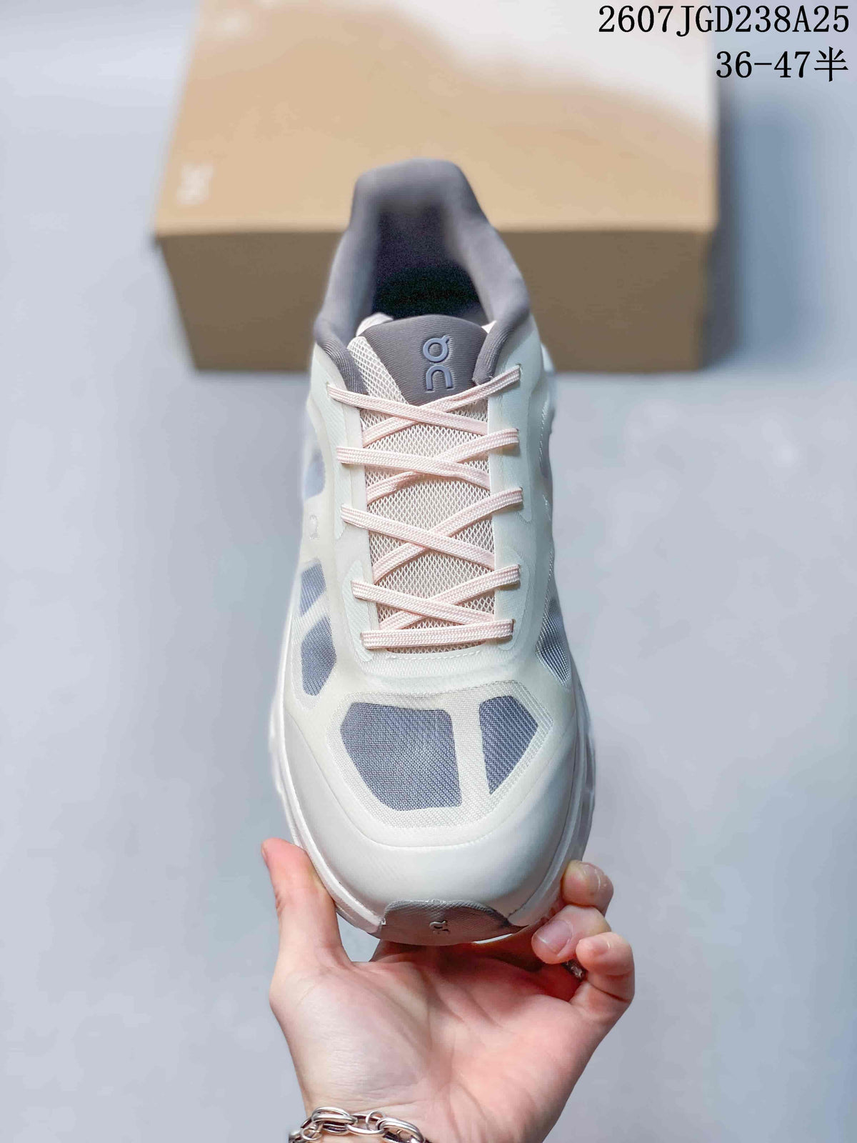 Top view of the sneaker showing the laces, tongue branding, and gray upper panels.