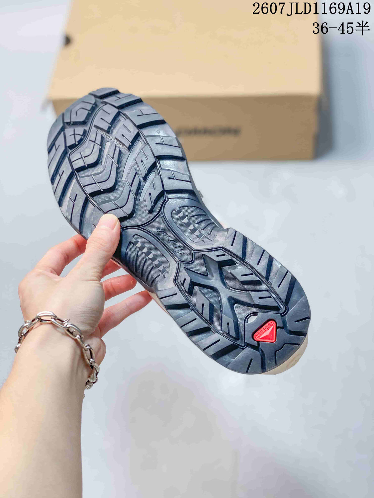 Close view of the Salomon XT-Quest outsole showing a black lugged tread pattern and red Salomon detail.