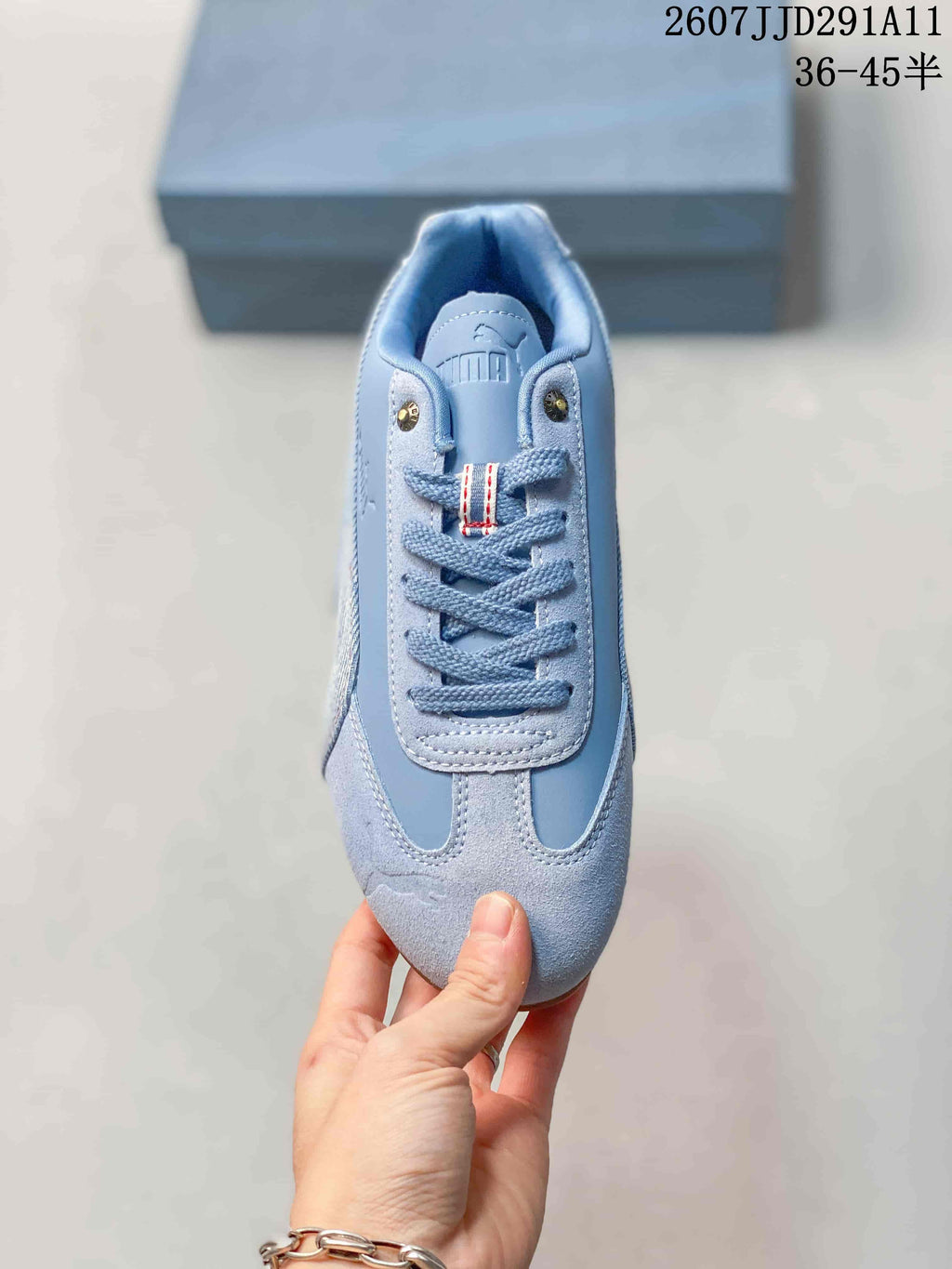 Top view of the sneaker showing the lace-up vamp, decorative eyelets, and rounded toe.
