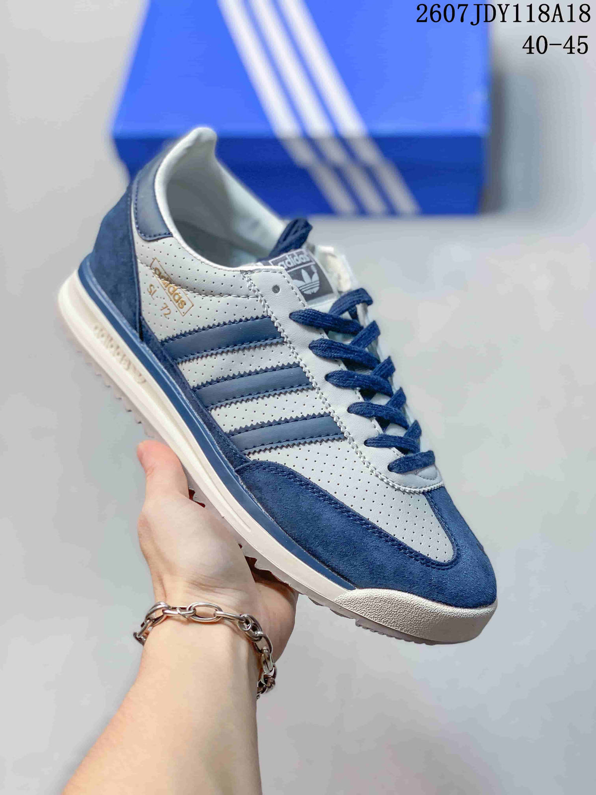 White and blue adidas SL 72 sneaker with blue stripes and a blue heel panel.