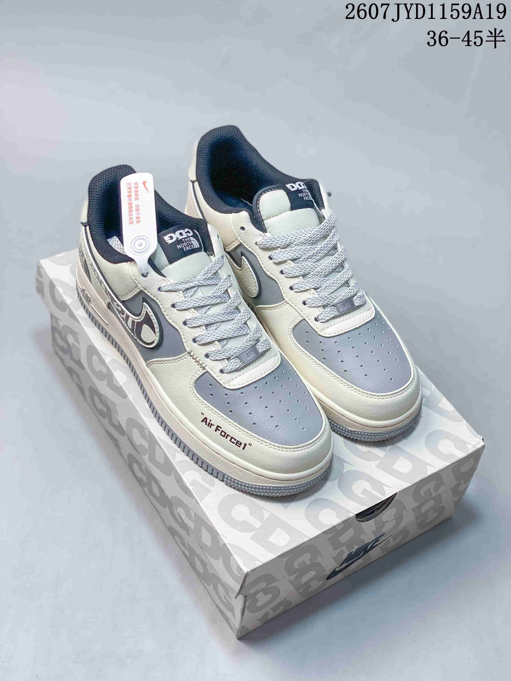 Pair of white and gray low-top sneakers displayed on a patterned shoebox; image text shows style code 2607JYD1159A19 and size range 36-45.
