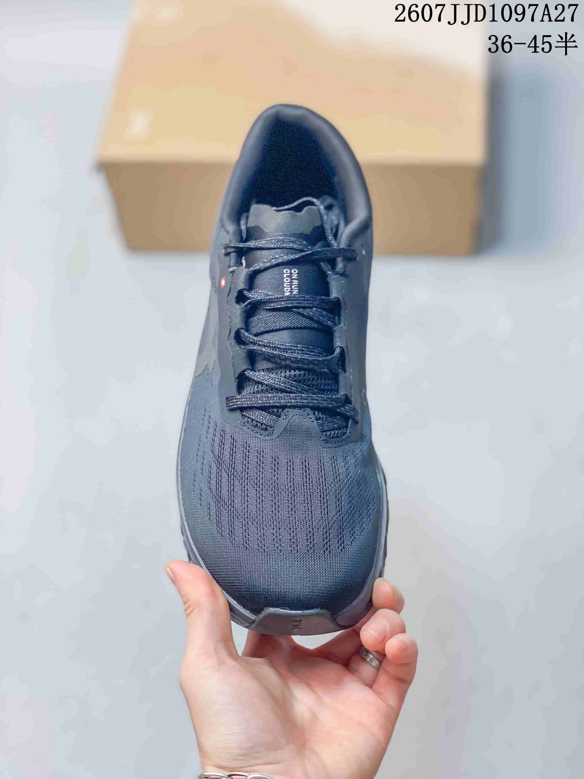 Top view of the dark gray sneaker showing the rounded toe, textured upper, tongue, and laces.
