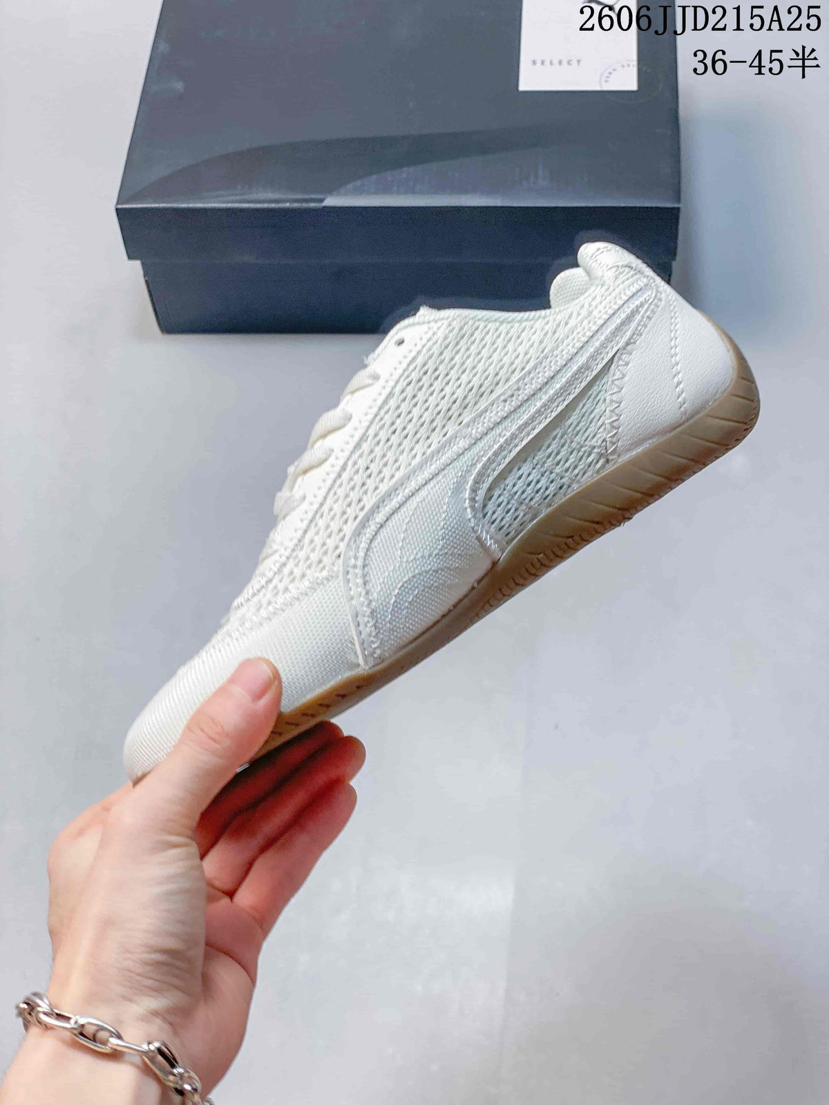 Side profile of an off-white low-top sneaker showing the PUMA side stripe, stitched overlays, and gum-colored outsole.