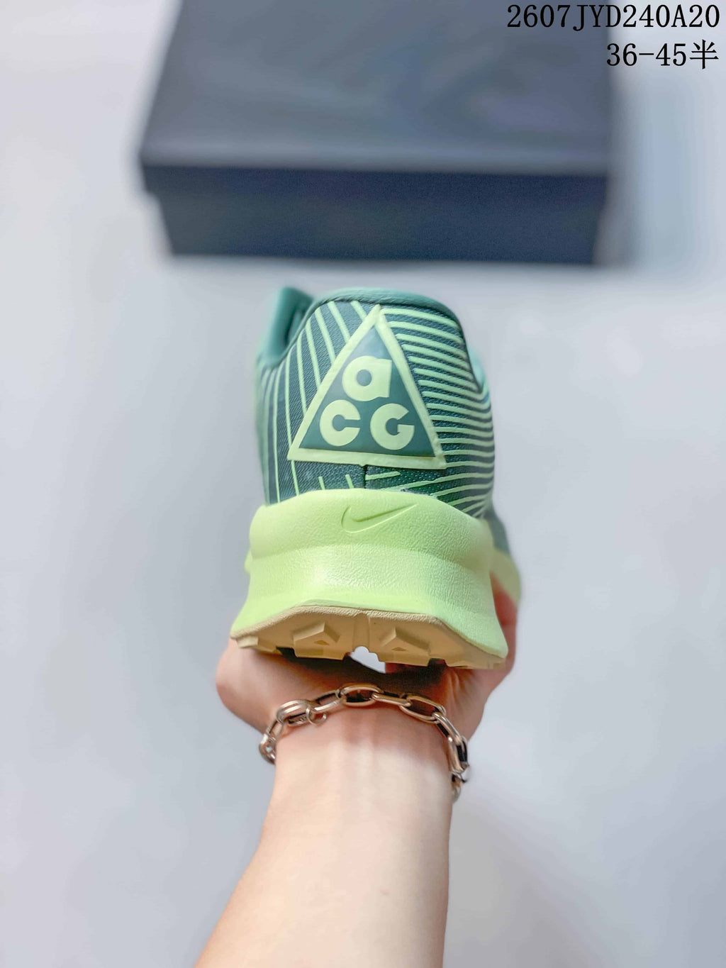 Rear view of the sneaker showing ACG heel branding, a pale lime heel section, and the outsole edge.